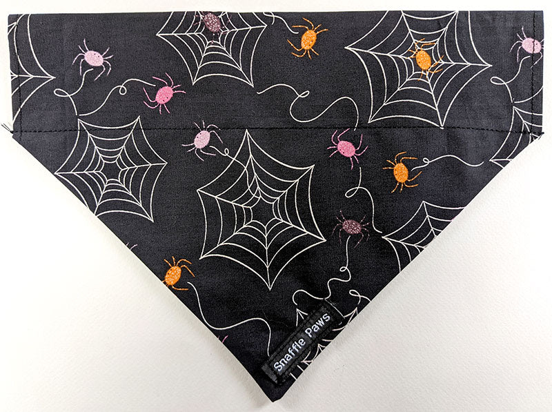 Snazzy pink and orange spiders and cobwebs dog bandana front